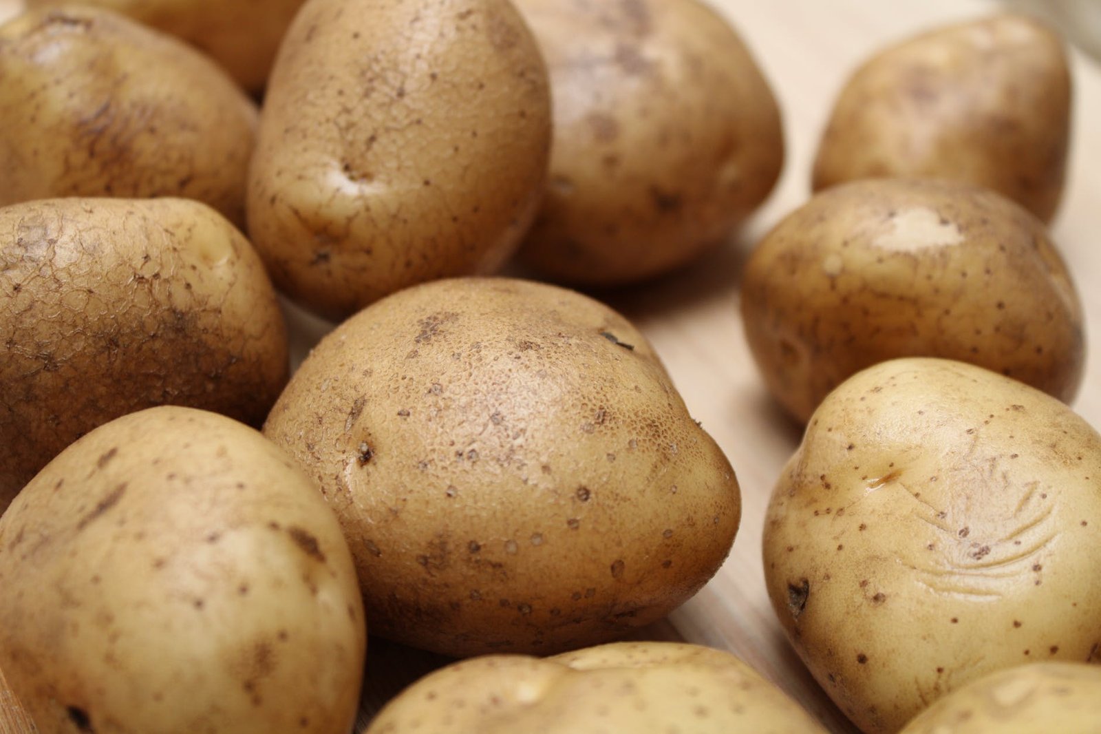 close up shot of potatoes on wooden surface